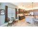 Bright kitchen with adjacent breakfast nook featuring dark cabinets, stainless appliances, and a large window at 4920 Sevilla Shores Dr, Wimauma, FL 33598