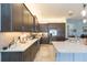 Modern kitchen featuring stainless steel appliances, tiled backsplash, and dark wood cabinetry with ample counter space at 4920 Sevilla Shores Dr, Wimauma, FL 33598