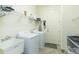 Well-equipped laundry room with washer, dryer, and sink for added convenience at 4920 Sevilla Shores Dr, Wimauma, FL 33598