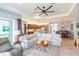 Open living space showcasing the kitchen, dining area, and living room with access to the lanai at 4920 Sevilla Shores Dr, Wimauma, FL 33598