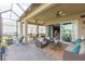 Inviting screened patio with comfortable seating and a picturesque lake view at 4920 Sevilla Shores Dr, Wimauma, FL 33598