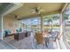 Screened-in patio with comfortable seating and a serene lake view at 4920 Sevilla Shores Dr, Wimauma, FL 33598