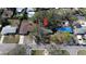 Aerial view of home with a new blue tarp, surrounded by mature trees and a well-maintained neighborhood at 4964 Huntington Ne St, St Petersburg, FL 33703