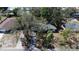 Aerial view of a single story home with a green roof surrounded by mature trees and lush landscaping at 4964 Huntington Ne St, St Petersburg, FL 33703