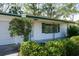Close-up of a well-maintained home featuring decorative shutters and a freshly painted facade at 4964 Huntington Ne St, St Petersburg, FL 33703