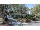Charming single-story home with mature trees and a driveway in a quiet residential neighborhood at 4964 Huntington Ne St, St Petersburg, FL 33703