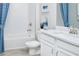 Bright bathroom with a shower-tub combo, white cabinets, framed art, and neutral tile floors at 5020 124Th E Ave, Parrish, FL 34219
