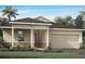 Charming single-Gathering home featuring a two-car garage, stone accents, and a well-manicured lawn at 5020 124Th E Ave, Parrish, FL 34219