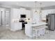 Bright kitchen featuring a large island, quartz countertops, stainless steel appliances, and stylish pendant lighting at 5020 124Th E Ave, Parrish, FL 34219