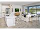 Open-concept living space with island seating, great backyard views, and comfortable, bright modern furniture at 5020 124Th E Ave, Parrish, FL 34219