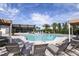 A beautiful community pool with plenty of lounge chairs and a covered seating area at 5020 124Th E Ave, Parrish, FL 34219