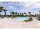 A beautiful view of the community pool surrounded by palm trees and lounge chairs at 5020 124Th E Ave, Parrish, FL 34219