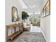 Inviting foyer with wood flooring, a decorative rug, a wooden table, and a white chair at 5526 Silver Sun Dr, Apollo Beach, FL 33572