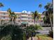 Stunning exterior view of a condo building with lush palm trees and landscaping at 6315 Shoreline Dr # 3305, Madeira Beach, FL 33708