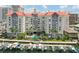 Aerial view of a high-rise community with a waterfront pool, boat docks and palm trees on a bright and sunny day at 700 S Harbour Island Blvd # 735, Tampa, FL 33602
