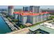 Aerial view of a gray high-rise complex next to the water with boat slips and downtown buildings visible in the background at 700 S Harbour Island Blvd # 735, Tampa, FL 33602
