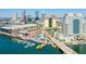 This city view features a waterfront area with boats docked, connected by a walking bridge and surrounded by urban architecture at 700 S Harbour Island Blvd # 735, Tampa, FL 33602