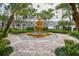 Exterior courtyard boasts a multi-tiered fountain, palm trees, and elegant brick paving, creating a serene outdoor space at 700 S Harbour Island Blvd # 735, Tampa, FL 33602