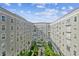 An airy courtyard featuring a verdant tropical landscape and blue skies is surrounded by a multi-story apartment building at 700 S Harbour Island Blvd # 735, Tampa, FL 33602