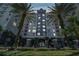 Elegant condominium exterior showcasing architectural details and lush landscaping and two large palm trees at 700 S Harbour Island Blvd # 735, Tampa, FL 33602