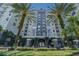 Elegant condominium exterior showcasing architectural details and lush landscaping and two large palm trees at 700 S Harbour Island Blvd # 735, Tampa, FL 33602