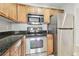 Kitchen with stainless steel appliances, wooden cabinets, and granite countertops at 700 S Harbour Island Blvd # 735, Tampa, FL 33602