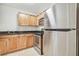 Kitchen with wooden cabinets and stainless steel appliances, including a fridge and oven at 700 S Harbour Island Blvd # 735, Tampa, FL 33602