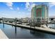 This is a waterfront view of the marina with boats docked, and a hotel tower with a clear, blue, and cloudy sky above at 700 S Harbour Island Blvd # 735, Tampa, FL 33602