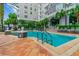 Modern building with a luxurious pool, palm trees, and cozy seating, offering a perfect blend of comfort and style at 700 S Harbour Island Blvd # 735, Tampa, FL 33602
