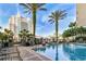 Inviting swimming pool area framed by palm trees and buildings under a blue sky, perfect for relaxation and recreation at 700 S Harbour Island Blvd # 735, Tampa, FL 33602
