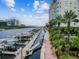 Scenic waterfront view of a marina with boats docked along the paved walkway, complemented by lush palm trees at 700 S Harbour Island Blvd # 735, Tampa, FL 33602