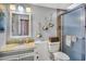 Charming bathroom featuring a granite-topped vanity, decorative accents, and a tiled shower at 707 Old Mill Pond Rd, Palm Harbor, FL 34683