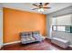 Bright bedroom with a ceiling fan, wood floors, and ample natural light from the window at 707 Old Mill Pond Rd, Palm Harbor, FL 34683