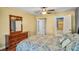 Cozy bedroom offering wood floors, natural light, ceiling fan and easy access to the attached bathroom at 707 Old Mill Pond Rd, Palm Harbor, FL 34683