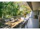 Relaxing deck with outdoor seating among lush greenery, perfect for entertaining and enjoying nature at 707 Old Mill Pond Rd, Palm Harbor, FL 34683