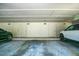 Interior garage with car and white storage lockers, for vehicles and storage space at 707 Old Mill Pond Rd, Palm Harbor, FL 34683