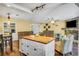Open kitchen featuring an island with butcher block countertop and modern appliances at 707 Old Mill Pond Rd, Palm Harbor, FL 34683