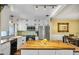 Updated kitchen with stainless steel appliances, white cabinetry, and butcher block countertop at 707 Old Mill Pond Rd, Palm Harbor, FL 34683