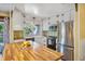 Bright kitchen with a white cabinets, a large island and stainless steel appliances at 707 Old Mill Pond Rd, Palm Harbor, FL 34683