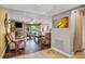 Comfortable living room with a stone fireplace, hardwood floors, and plenty of natural light at 707 Old Mill Pond Rd, Palm Harbor, FL 34683