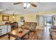 Spacious living room featuring wood floors and an adjoining dining area at 707 Old Mill Pond Rd, Palm Harbor, FL 34683