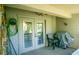 Covered back patio with grill and ceiling fan provides space for relaxation and outdoor enjoyment at 707 Old Mill Pond Rd, Palm Harbor, FL 34683