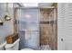 Tiled shower with glass door, and a rainfall showerhead in the bathroom at 707 Old Mill Pond Rd, Palm Harbor, FL 34683