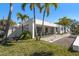 Exterior view of a modern home featuring a well-maintained lawn and elegant pathway at 741 Mandalay Ave, Clearwater Beach, FL 33767