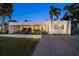 Contemporary home with brick driveway, modern landscaping, and stylish design elements at 741 Mandalay Ave, Clearwater Beach, FL 33767