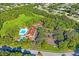 Aerial view showing the Beacon Woods East clubhouse, tennis courts, shuffleboard and pool at 8204 Reynolds Dr, Hudson, FL 34667