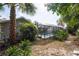 Lush backyard showcasing the pool area, surrounded by landscaping and a privacy screen at 8204 Reynolds Dr, Hudson, FL 34667
