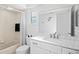 Bright bathroom features a modern vanity, shower with a patterned shower curtain, and a large mirror at 8204 Reynolds Dr, Hudson, FL 34667