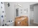Bathroom featuring a shower and tub, toilet, and vanity with a large mirror at 8204 Reynolds Dr, Hudson, FL 34667