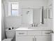Bathroom features a modern vanity, shower with a patterned curtain, and a large mirror at 8204 Reynolds Dr, Hudson, FL 34667
